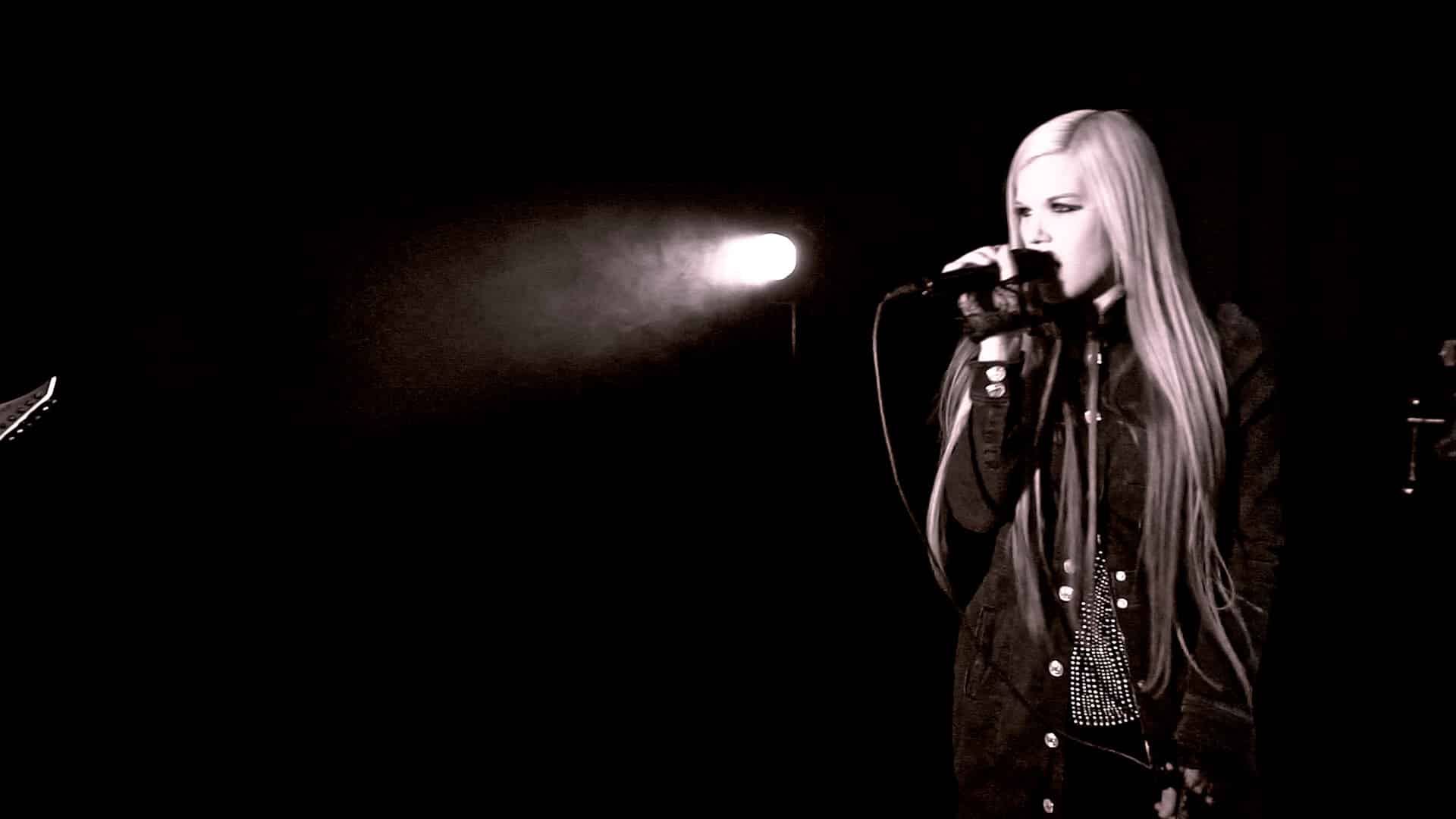 Single spotlight on the vocal — still from the "Down In Flames" music video