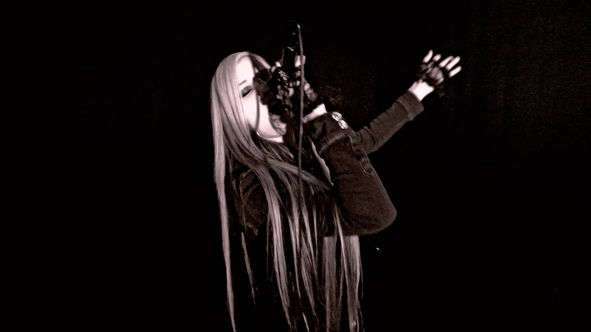 Charlotte reaching into the dark — still from the "Down In Flames" music video