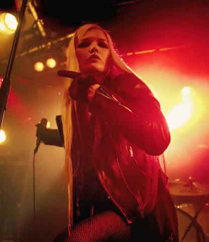 Glasgow Kiss performing under amber stage lights